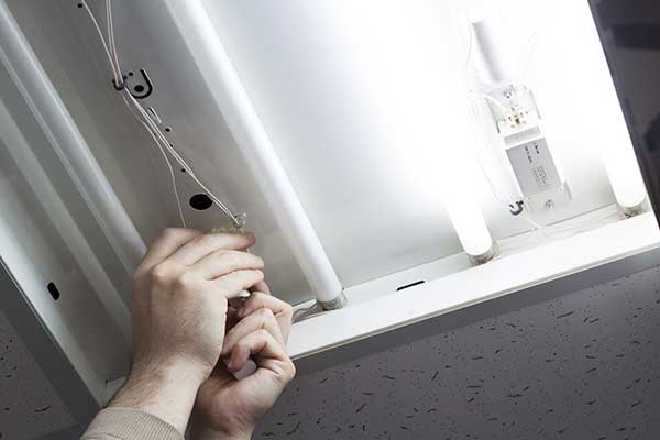 Close up of a worker fixing and replacement a faulty fluorescent light